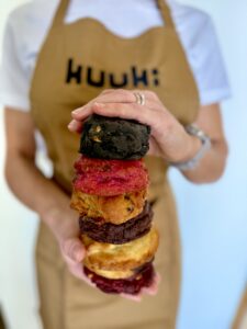 woman hands a tower of different color and taste american style cookies